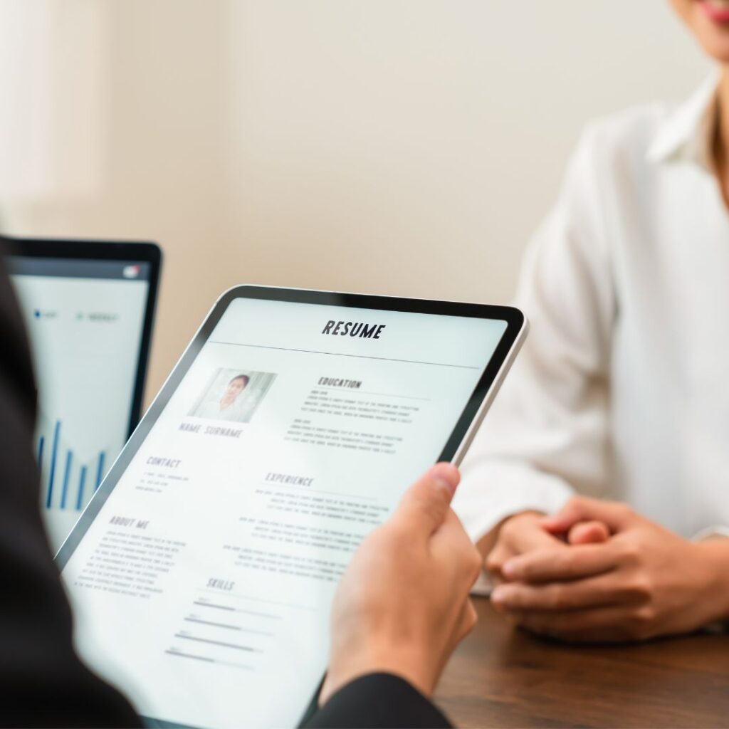 person looking at resume on a tablet